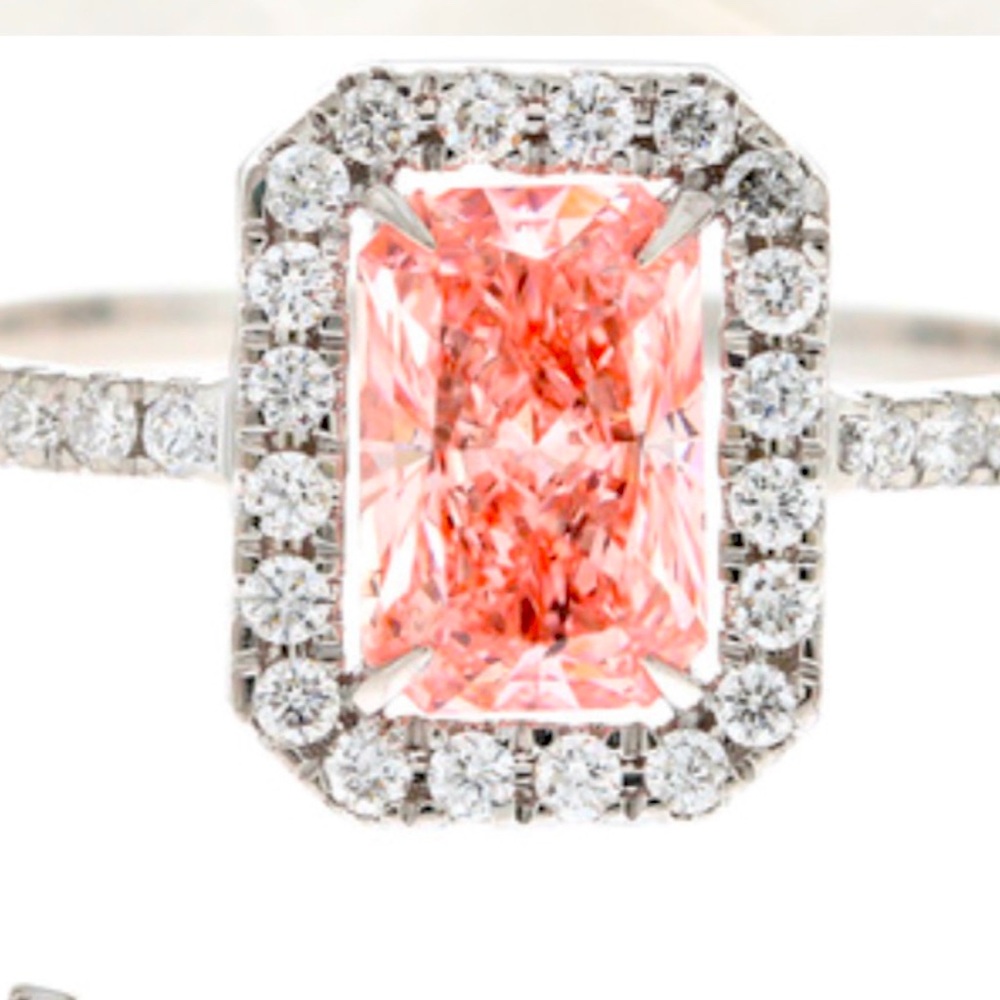 A one carat fancy vivid intense, pink diamond center stone, surround. 28 ct